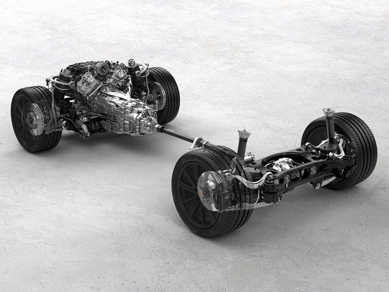 Technische Darstellung des Fahrwerks eines Porsche mit sichtbar dargestelltem Antriebsstrang, Achsen und Rädern auf neutralem Hintergrund.