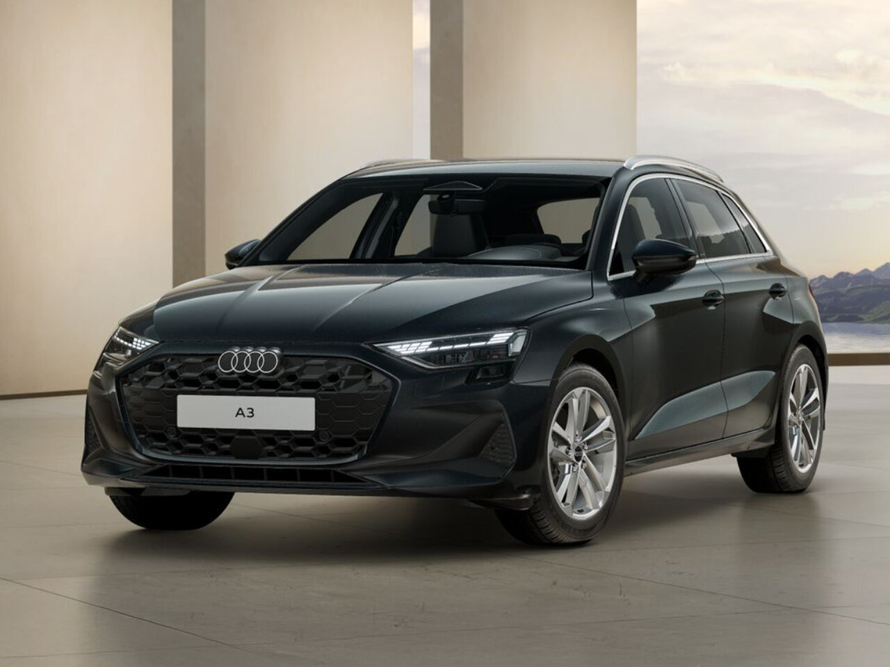 Dunkelgrauer Audi A3 Sportback steht in modernem Innenraum mit hellem Boden und Landschaft im Hintergrund