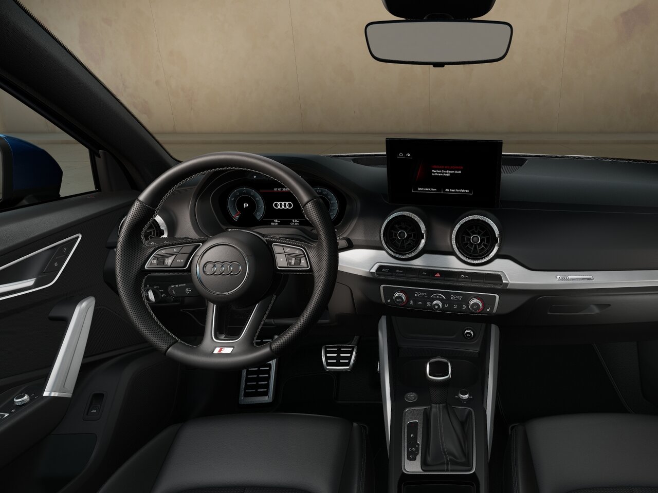 Cockpit des Audi Q2 mit Multifunktionslenkrad, freistehendem Display, digitalen Instrumenten und runden Lüftungsdüsen in Frontansicht