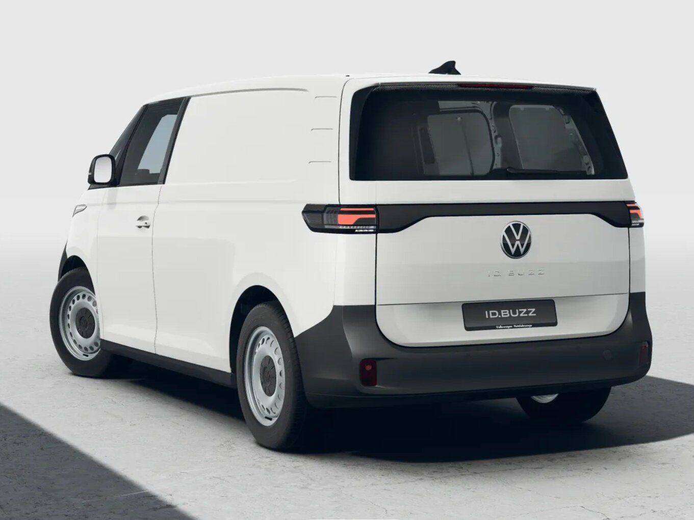 Volkswagen ID. Buzz Cargo in Heckansicht schräg von hinten vor hellem Studiohintergrund mit geschlossener Ladefläche