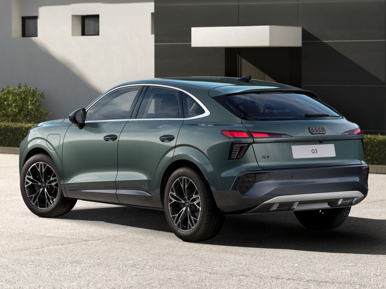 Audi Q3 Sportback in Heckansicht schräg von hinten vor moderner Architektur mit durchgehendem LED-Leuchtenband und coupéhafter SUV-Silhouette