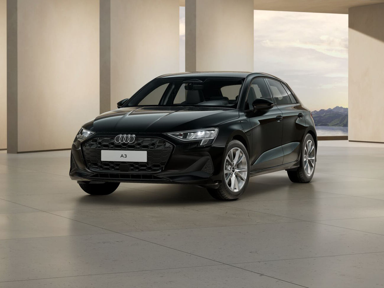 Audi A3 Sportback TFSIe in schwarzer Lackierung in moderner Architekturhalle aus Front-Dreiviertel-Perspektive geparkt