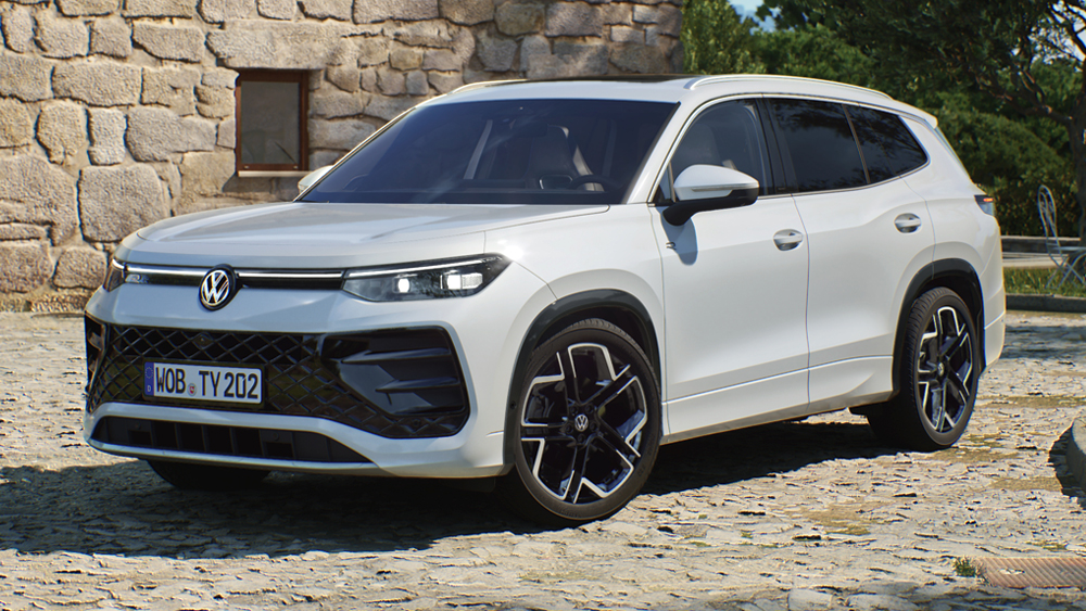 Volkswagen Tayron in Weiß, dynamische Frontansicht vor Natursteinfassade auf hellem Kopfsteinpflaster